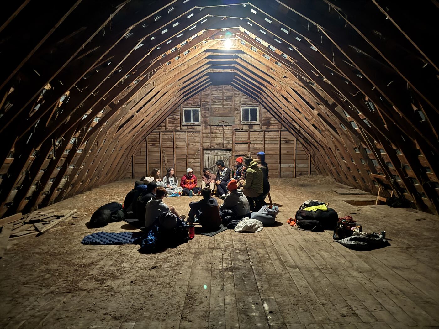 The frisbee team camping in a barn